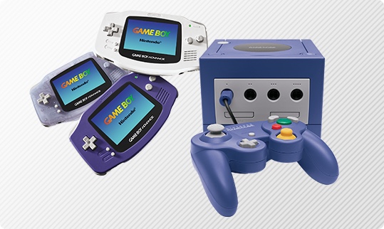Game Boy Advance handheld systems in white, blue, and clear colors and one Nintendo GameCube system with controller.