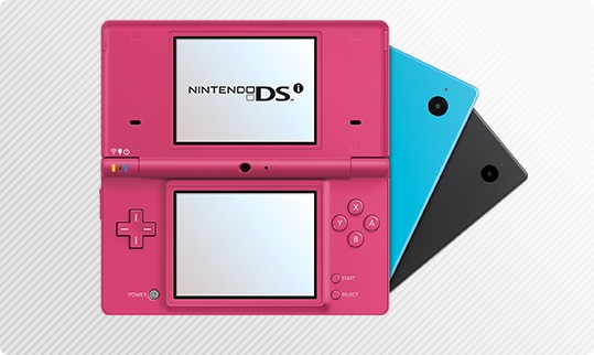 Nintendo 3DS handheld systems in pink, blue, and black colors. One system is open to show dual screens.